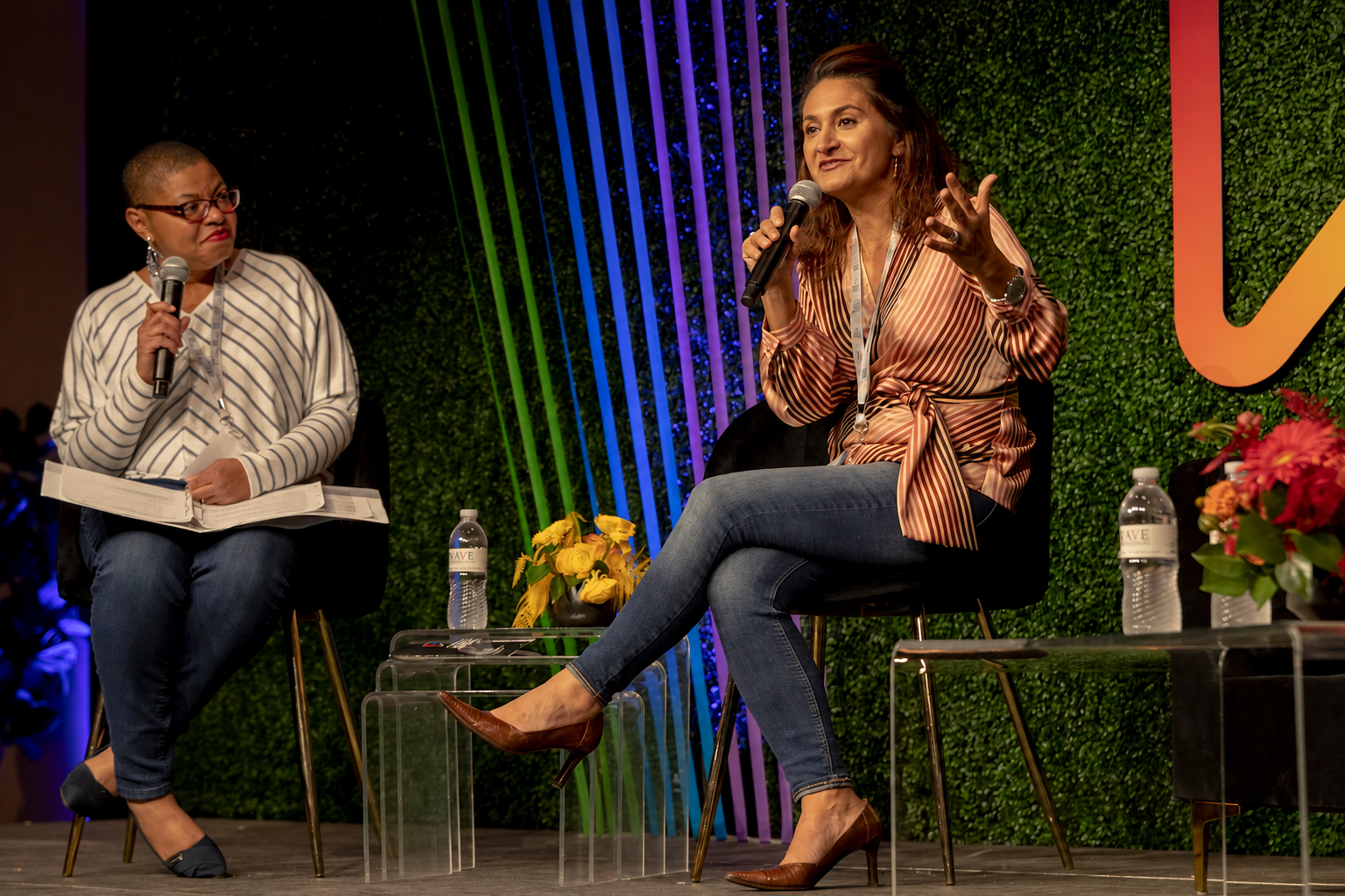 Marcela Shine speaking on stage at a Comcast small business event